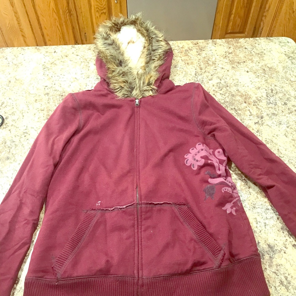 Zip up sweater with full fur hood and liner.